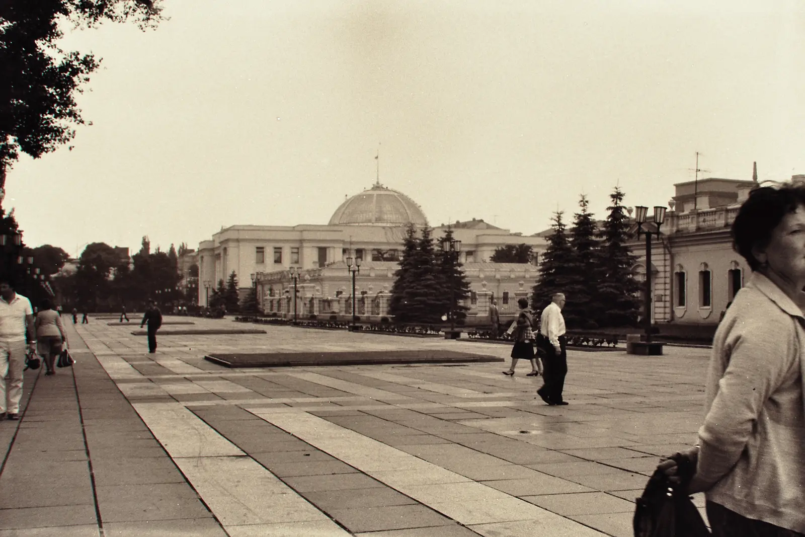 Two visitors in the courtyard of a brick cathedral, Kiev Pechersk Lavra