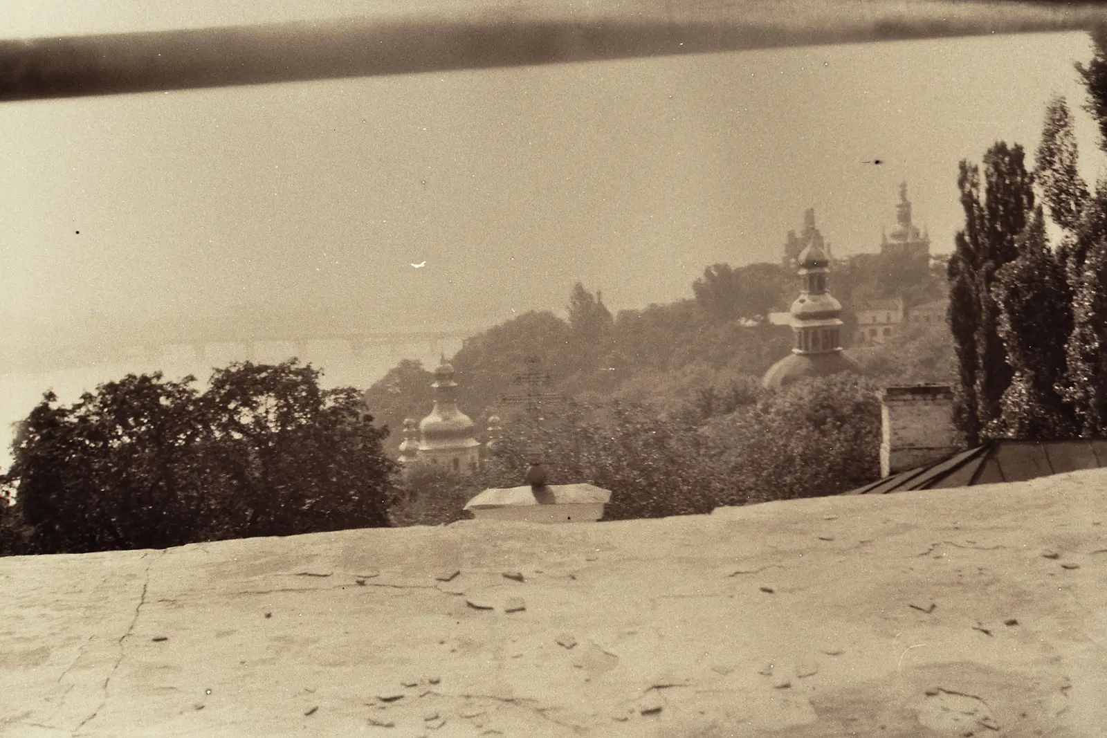 Fountains along the boulevard with a bell tower fading into the haze
