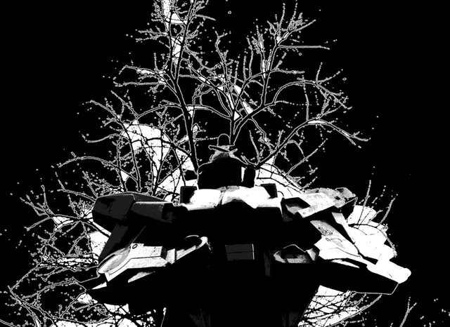 Giant robot statue against bare branches, high contrast
