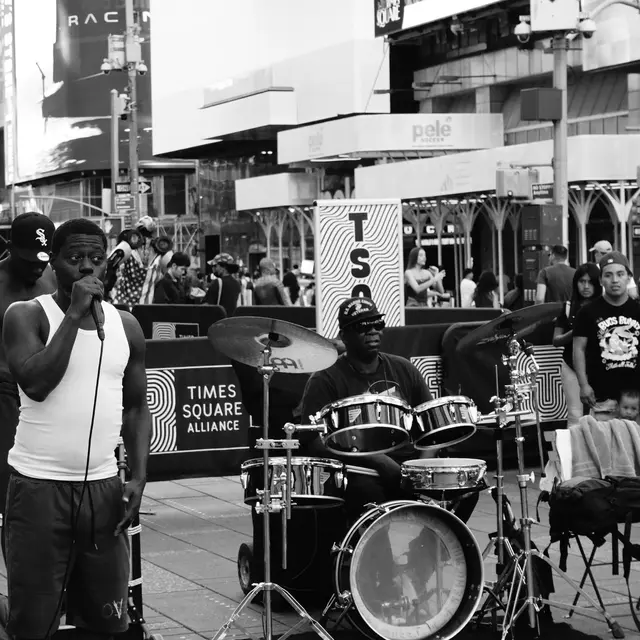 Busker on the mic with drummer, Times Square Alliance