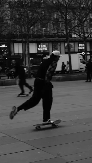 Skater pushing down the boulevard past Five Guys