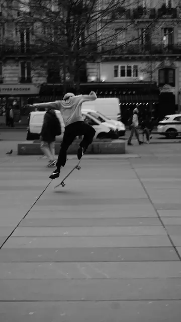Mid-air kickflip caught against Haussmann façades