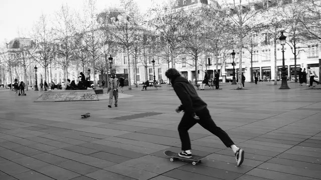 Skater pushing hard across the wide plaza