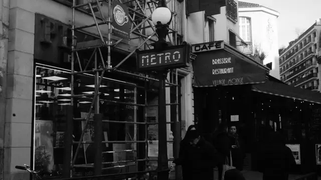 Métro sign and Village Monge brasserie under scaffolding