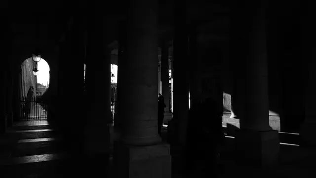 Columns and lanterns of the Palais-Royal colonnade in shadow