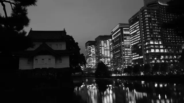 Imperial Palace watchtower against the Marunouchi lights, reflected in the moat