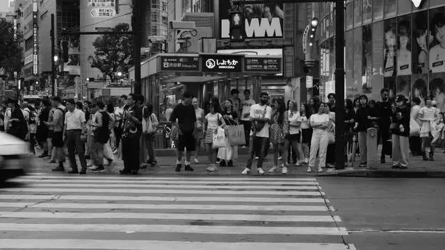 Waiting for the light at Shibuchika, H&M glowing above