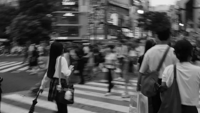 Schoolgirl with phone cutting through the scramble