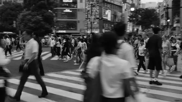 Panned frame of commuters on the crossing