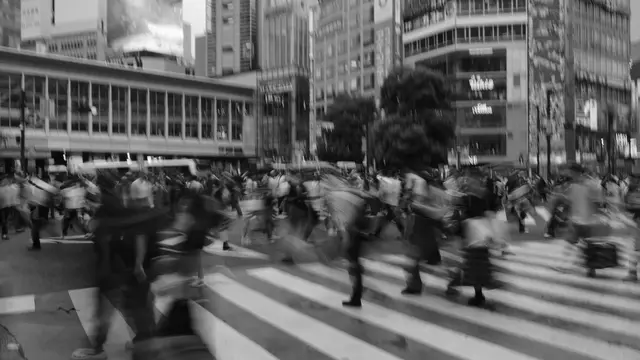 Crowd surging over the zebra stripes, motion blur